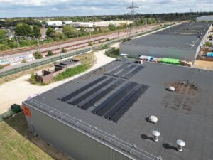 Rooftop solar arrays on an Indurent industrial unit beside the railway, Peterborough