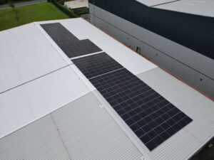 Close drone view of rows of JA Solar bifacial panels on Renusol MetaSole+ fixings on a trapezoidal roof in Rotherham