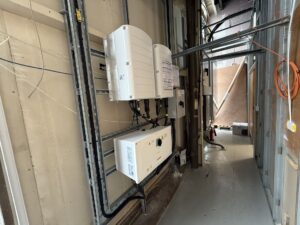 SolarEdge Synergy inverter units installed on a wall inside Pyronix Ltd's building in Rotherham